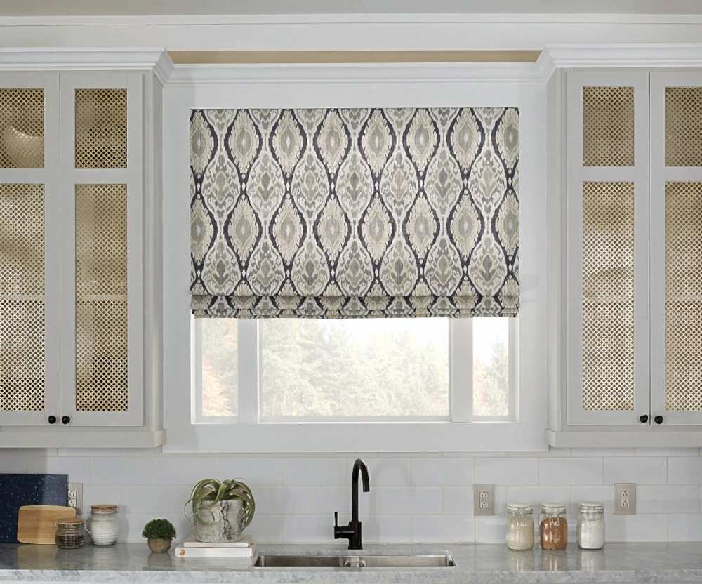 Roman Shade letting in natural light into a kitchen above a sink.