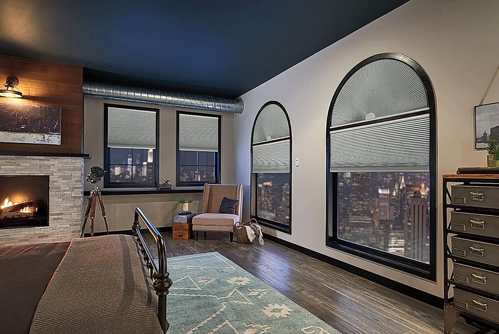 Custom made cellular shades covering curved and regular windows in a master bedroom.